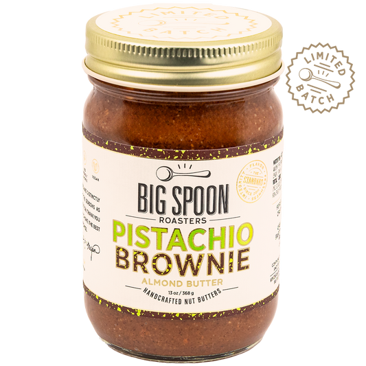 Jar of Big Spoon Roasters Pistachio Brownie almond butter with gold lid on a white background