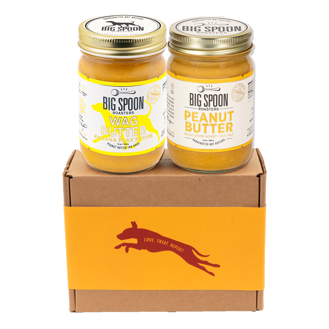 Two jars of Big Spoon Roasters nut butter - Banana Flax Wag Butter and Peanut Butter with Wildflower Honey on a branded box 