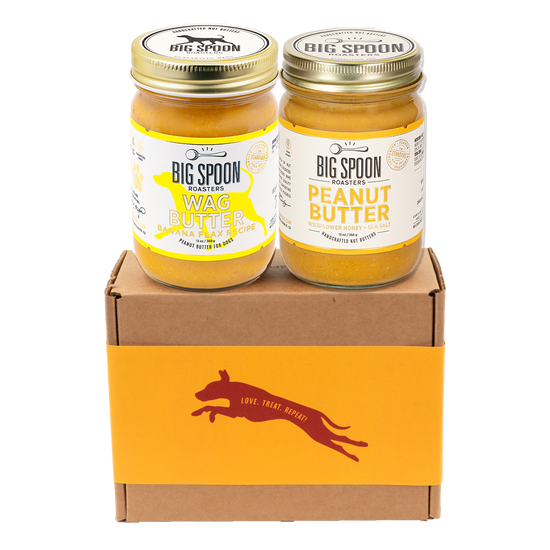Two jars of Big Spoon Roasters nut butter - Banana Flax Wag Butter and Peanut Butter with Wildflower Honey on a branded box 