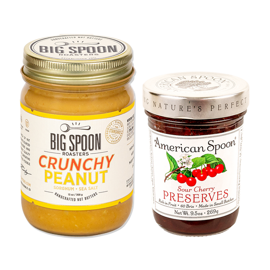 One jar of peanut butter from Big Spoon Roasters and one jar of sour cherry preserves from American Spoon on white background