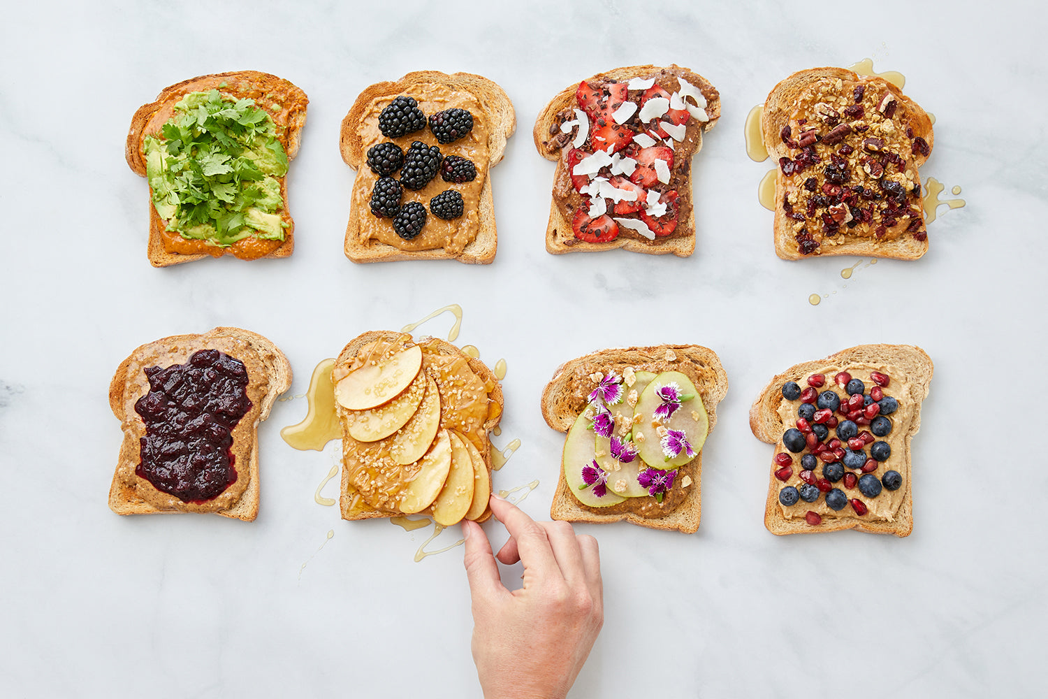 hand reaches in to eight varieties of toast