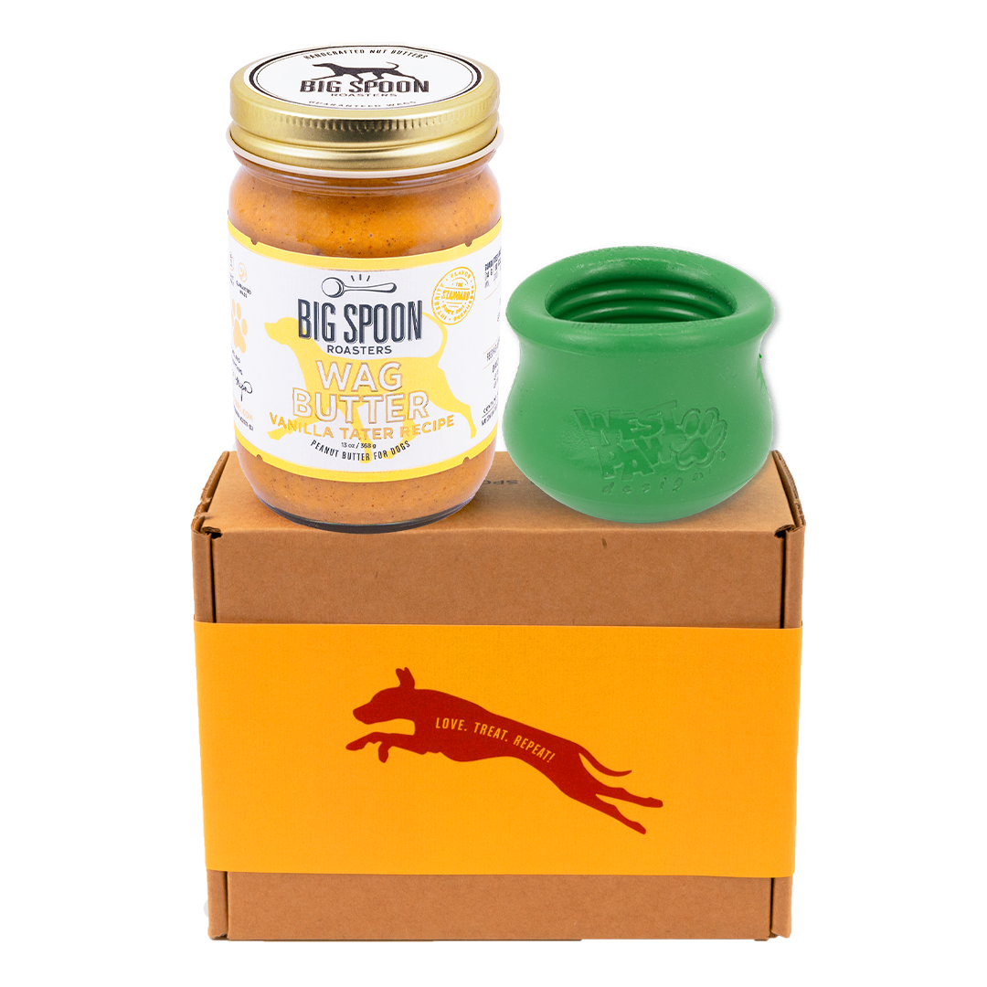 Jar of Vanilla Tater Wag Butter and a green West Paw Toppl toy on top of a gift box