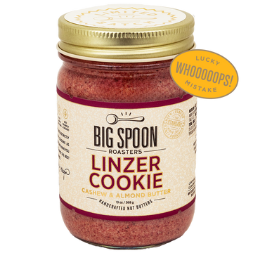 Jar of Big Spoon Roasters Linzer Cookie cashew and almond butter wth a badge overlaid that says LUCKY WHOOPS MISTAKE