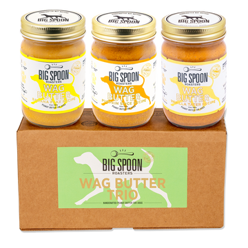 Three jars of Big Spoon Roasters Wag Butter on a cardboard box with the brand logo.